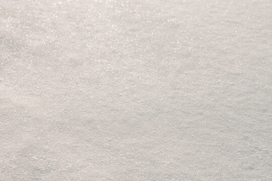 Sparkling snow texture with soft winter bokeh background