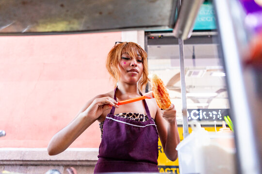 Mexican street food vendor prepare grilled corn snack