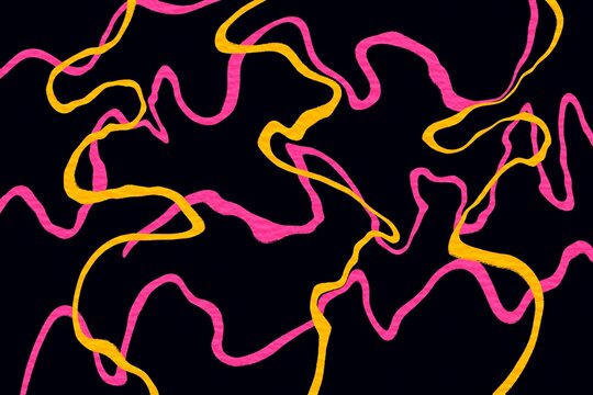 Liquid marble abstract texture with pink and yellow ribbons