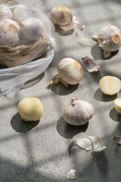 Garlic bulb and clove in mesh bag with sunlight