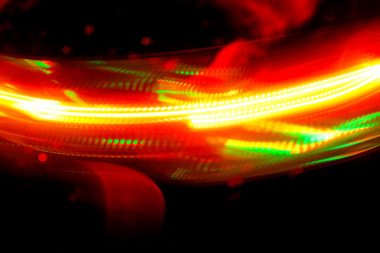 Abstract red and green light trail on black background