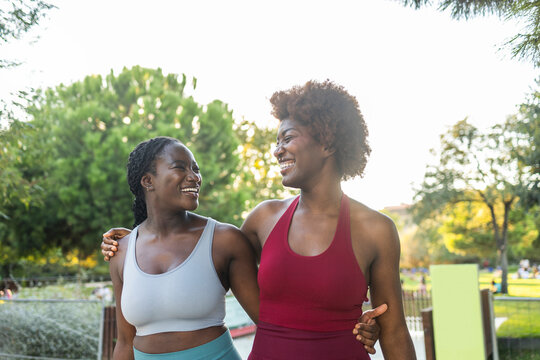 Black female friends embrace after outdoor workout