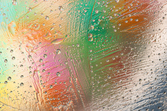 Colorful water droplet texture on abstract glass surface
