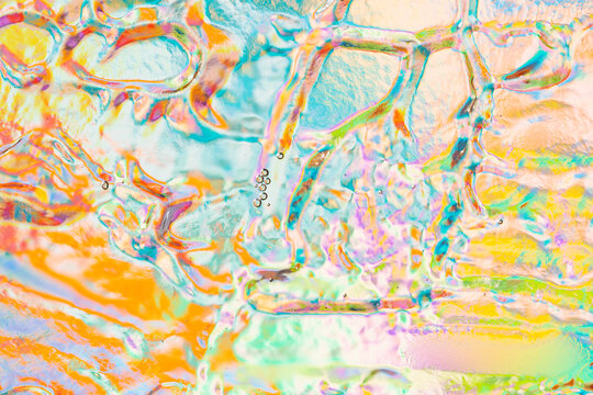Colorful abstract water droplets on pastel glass background