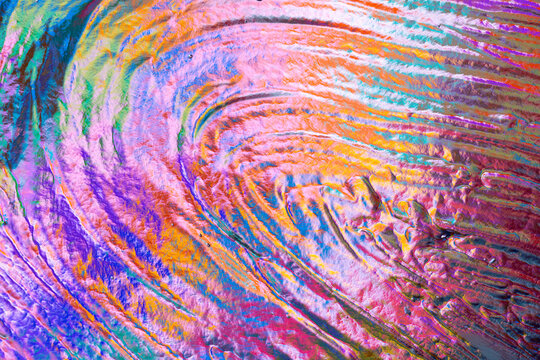 Colorful abstract paint texture with swirling brushstroke pattern