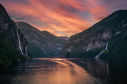 Sunset over Geirangerfjord waterfall and mountain valley