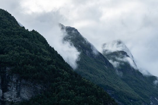 Misty mountain peaks in norway's Geirangerfjord landscape