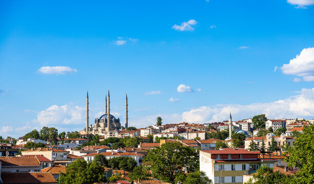 Ottoman mosque and red-roofed town beneath blue sky