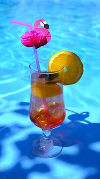 Friends drinking cocktails by the pool. Selective focus.