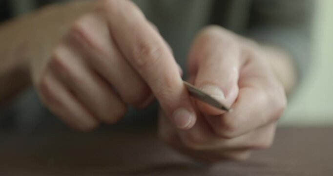 Close-up male hands do filing nails manicure. 4K 10-bit