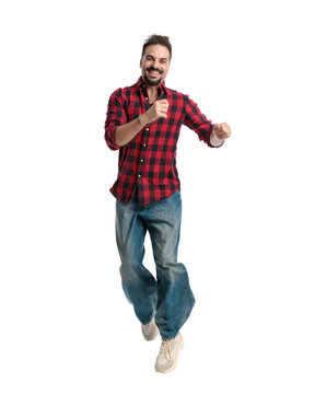 Joyful casual man jumping and laughing