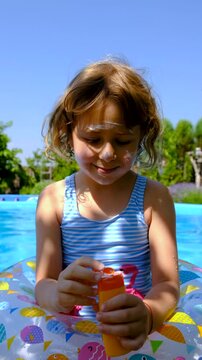 The child swims in the pool. Selective focus.