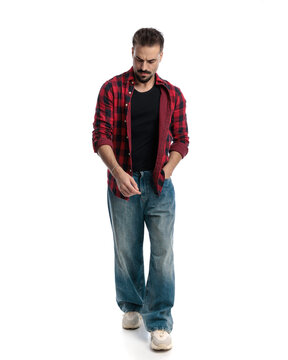 Trendy man with hand in pocket looking down