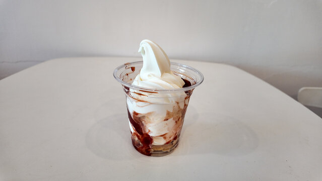 Creamy Soft Serve Ice Cream in Clear Cup with Chocolate Swirl