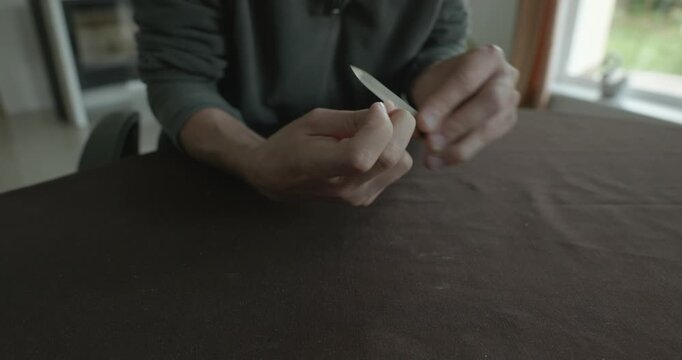 Close-up male hands do filing nails manicure. 4K 10-bit