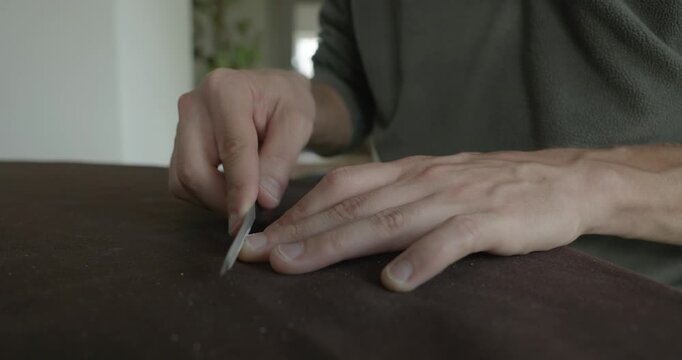 Close-up male hands do filing nails manicure. 4K 10-bit