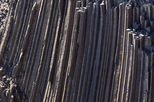 Close view of tall basalt columns along the Hengifoss and Litlanesfoss trail in East Iceland, showing angular rock faces, fine fractures and a repeating geological pattern.