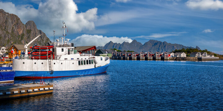 Harbor of Svolvaer with ship, Rorbuer and dramatic mountains in the Lofoten Islands, Norway