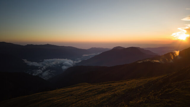 Mountain landscape with sunset, fog and grassy slopes. horizon line