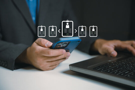 Recruitment and hiring concept with a business professional using a smartphone and laptop to review candidate profiles, screen job applicants, and select qualified talent using digital HR technology.