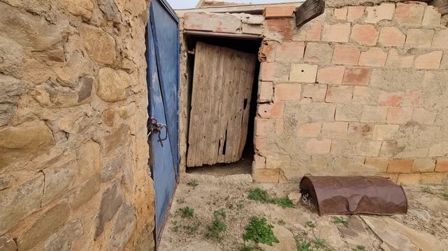 Old Rural House Entrance with Antique Wooden Door and Traditional Stone Wall