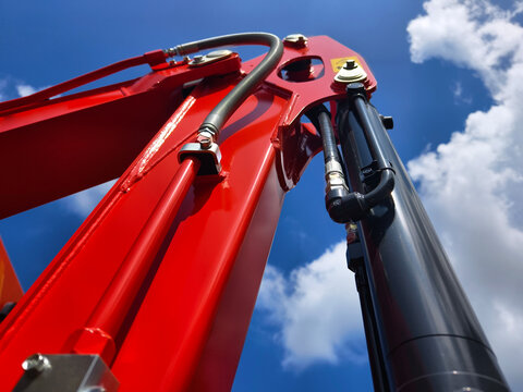 Compact hydraulic excavators parked outdoors with buckets lowered and metal tracks