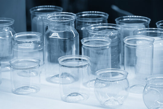 A group of wide mouth bottles in a modern blue tone scene