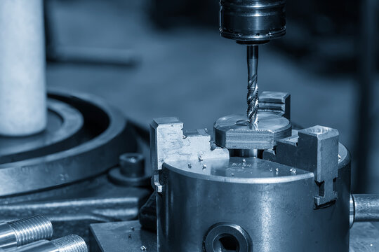 Internal thread making process on a  milling machine using a tapping tool in a blue tone scene