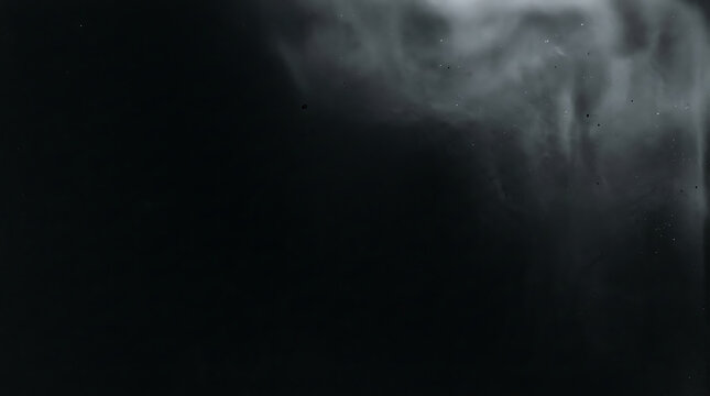 Abstract black and white smoke texture with soft ethereal light and dark moody atmosphere.