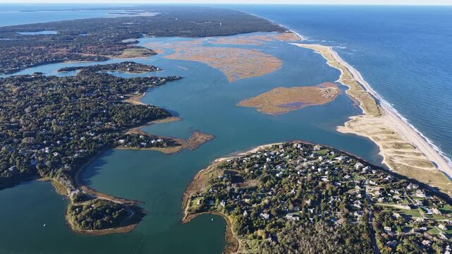A bird's eye view of Nauset Beach on outer Cape Cod, MA, also shows Mill Pond and Orleans Town Cove which is connected to the Atlantic Ocean. This area is a popular east coast vacation destination.