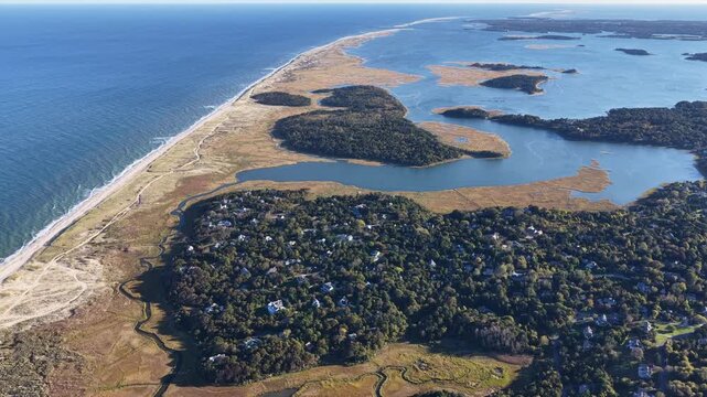 A bird's eye view of Nauset Beach on outer Cape Cod, MA, also shows Pleasant Bay which is connected to the Atlantic Ocean. This scenic area is a popular east coast vacation destination.