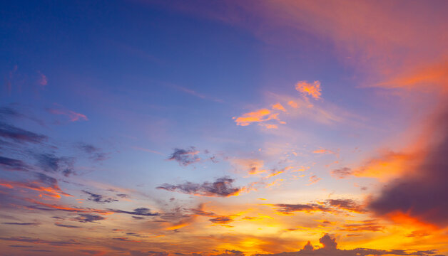 Dramatic Sunset Sky with Colorful Pastel Clouds Panoramic Banner,Panoramic wide view of a stunning sunset sky featuring a rich gradient of purple, violet, and warm orange clouds, ideal for nature land