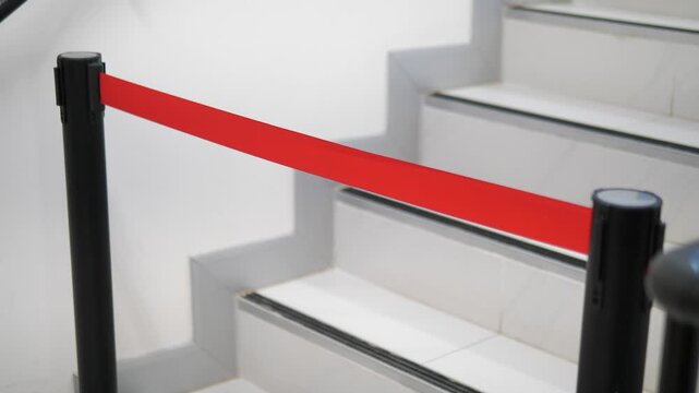 Close up of retractable barrier belt blocking staircase