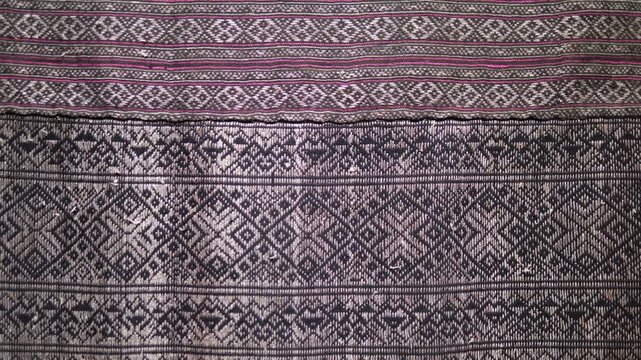 Close up of traditional ancient woven fabric with intricate geometric patterns