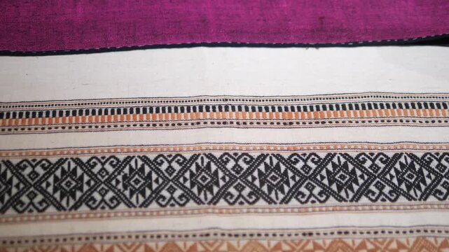 Close up of traditional white woven fabric with intricate geometric patterns