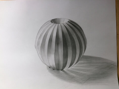 Realistic pencil drawing of striped spherical vase with open top, showing light and shadow with optical illusion effect and cast shadow on surface.