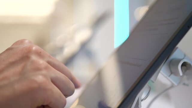 Close up of person using digital tablet screen on display