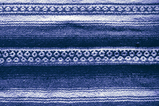 Handmade woven rough pile blue patterned scatter rug background backdrop
