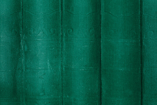 Old aged vintage antique green book spine cover background backdrop. Vintage books concept
