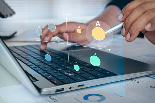 Business professional pointing stylus at laptop screen with digital market positioning matrix overlay showing price and quality analysis, concept of product competitive strategy.