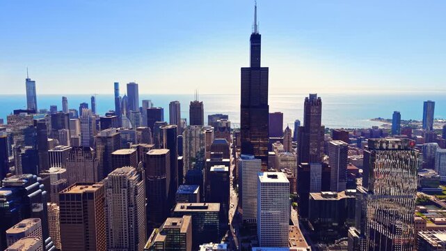 Willis Tower and downtown skyscrapers, Chicago. High rise office towers, Lake Michigan, blue sky, city grid and urban buildings.