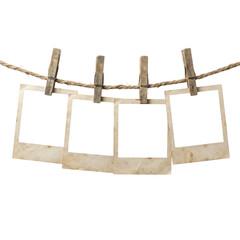 Four empty polaroid photo frames hanging on a rope © Raja