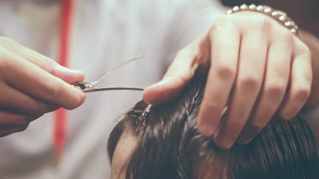 Haircut closeup hands scissors hair clips. Barber client men grooming salon.