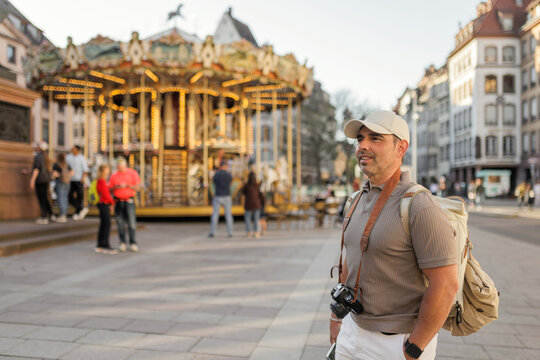 Man sightseeing near carousel in Strasbourg