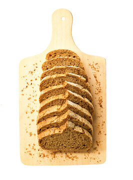 Sliced whole grain buckwheat bread with flax seeds on cutting board , isolated on white background, top view.