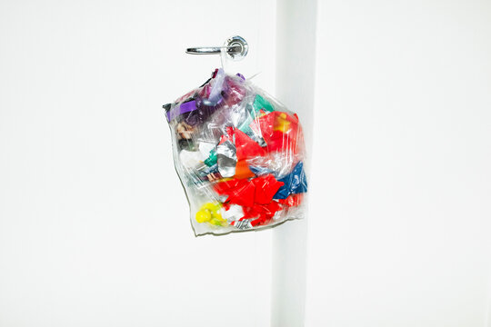 Recycling plastic: transparent bag full of colourful plastic trash