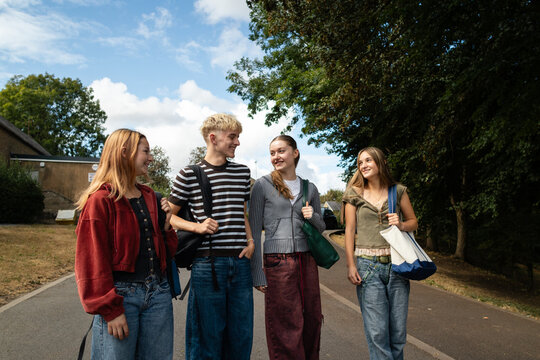 A cheerful group pause on the way home from class