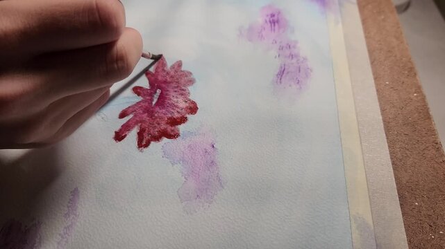 Close Up of Artist Hand Painting Red Floral Design with Fine Brush