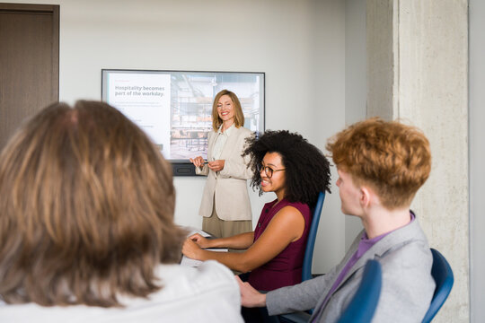 Meeting in an Office With a Woman Presenting to a Group