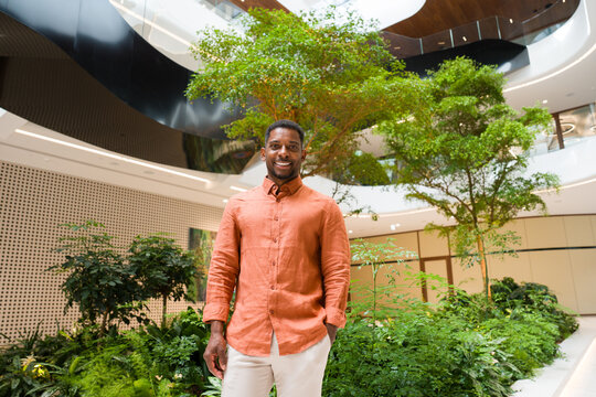 Man Standing in a Garden Area of Office Building